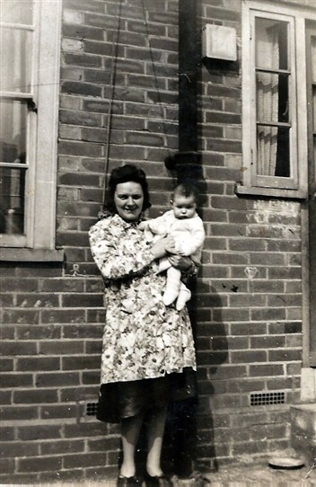 Photo:Ethel Beckwith with daughter Joan at the back door of 86 Tweeddale Road, 1945.