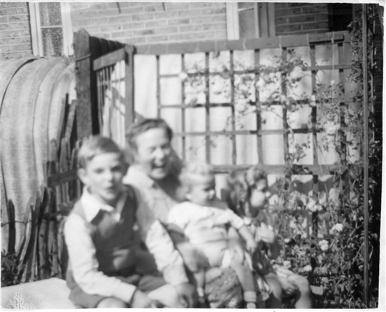 Photo:Rose Prior with her children near the Anderson shelter at Torre walk c.1947