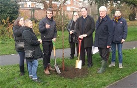 Photo:Cllr Sam Weatherlake and Tom  Brake plant the final tree in the new Wrythe orchard, while members of  the Friends of the Wrythe look on. November 30th 2019